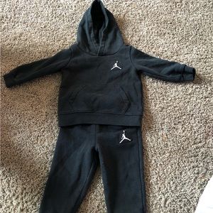 A handful of baby clothes, ranging from 12M to 18M